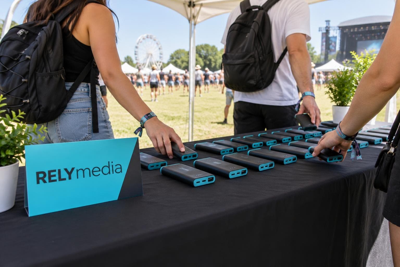 People charging phones at a festival charging tent