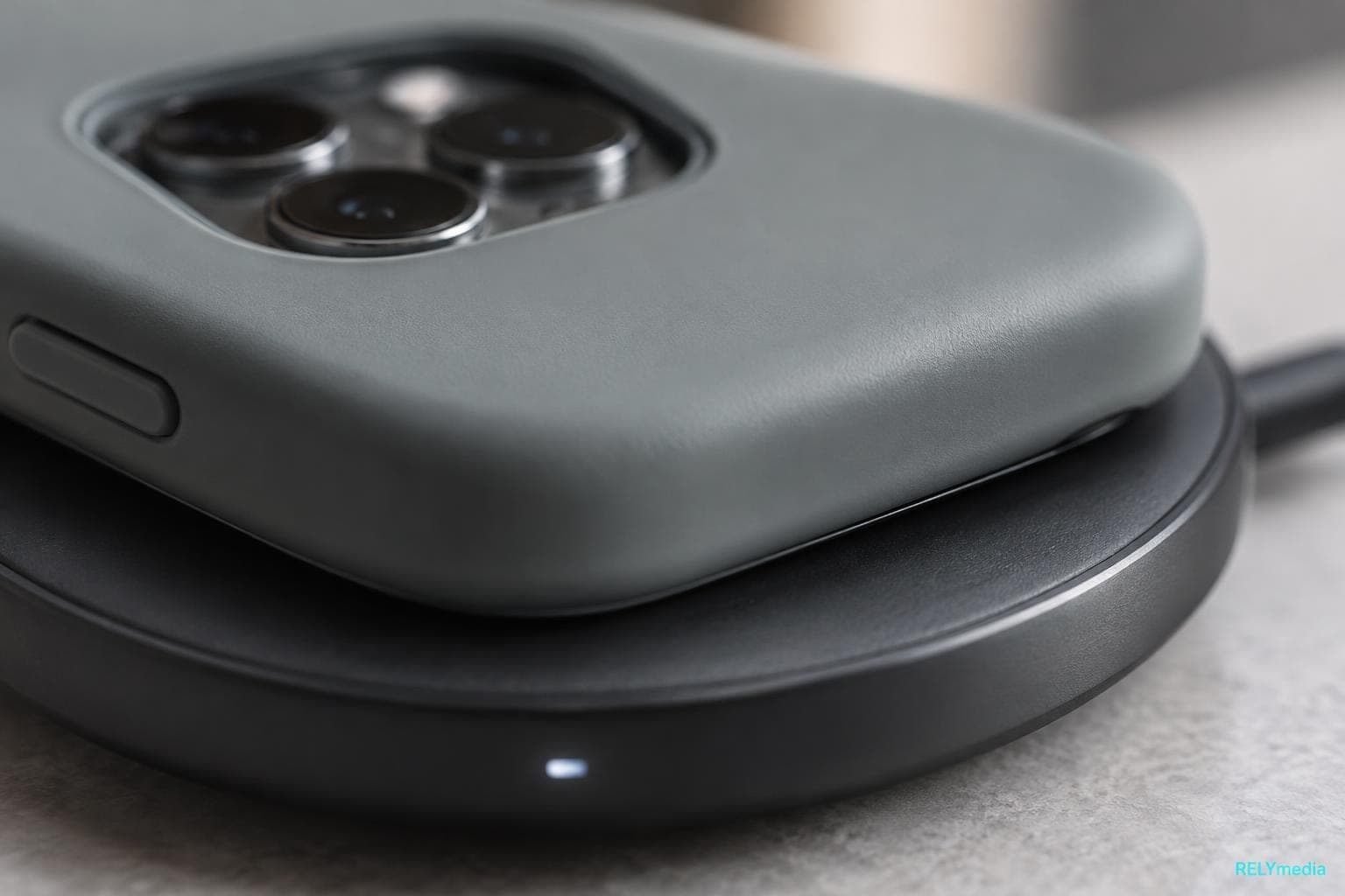 Close-up of a cased phone resting on a wireless charging pad