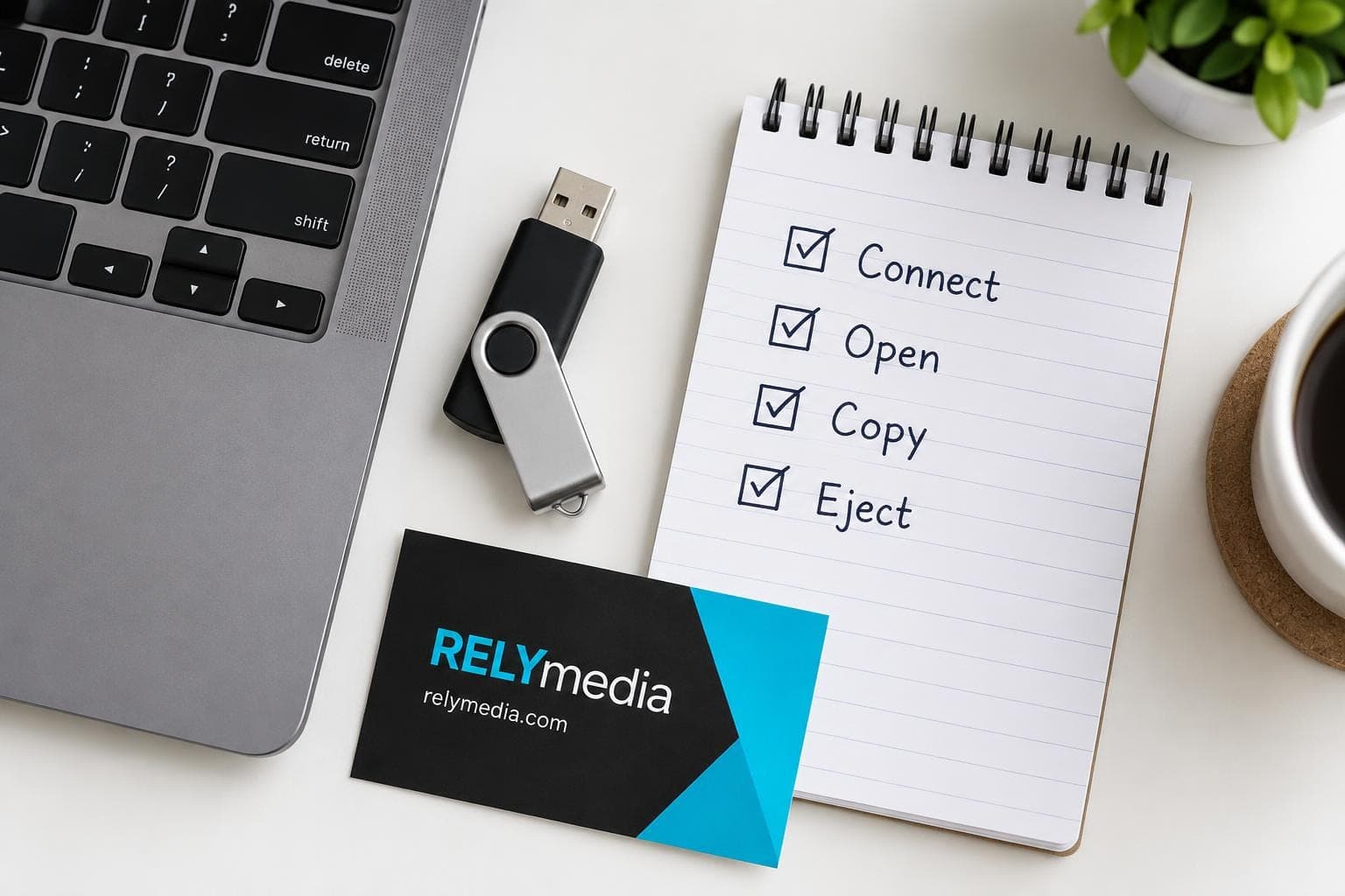 Flat lay of a flash drive beside a written checklist