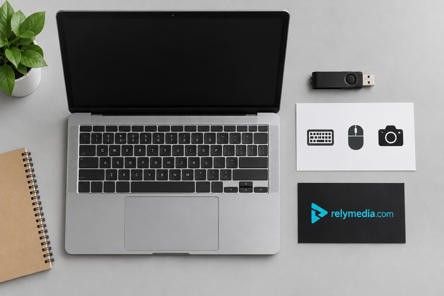 Flash drives, cables, and a laptop laid out on a desk