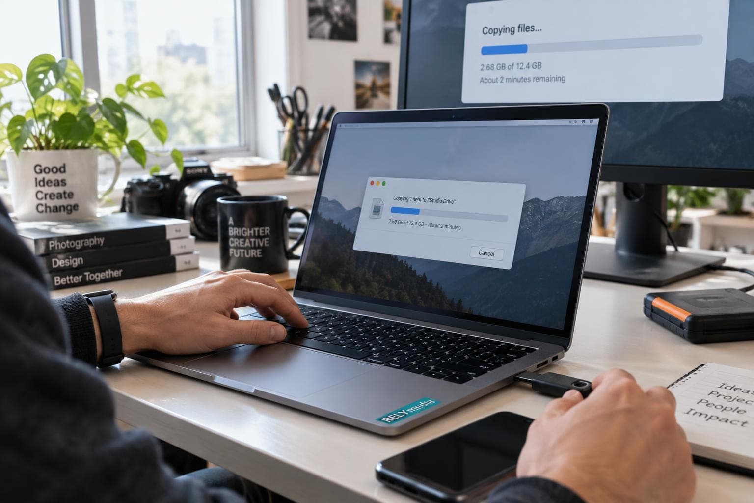 Person copying video files to a USB drive at a desk